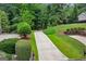 Long, winding driveway leading to a private estate surrounded by lush greenery at 770 Spalding Heights Dr, Atlanta, GA 30350