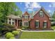Charming brick home with manicured landscaping and classic architectural details at 770 Spalding Heights Dr, Atlanta, GA 30350