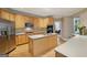 Bright kitchen featuring light wood cabinets, stainless steel appliances, and an island at 770 Spalding Heights Dr, Atlanta, GA 30350