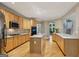 Bright kitchen with island, wood cabinets, stainless appliances, and hardwood flooring at 770 Spalding Heights Dr, Atlanta, GA 30350