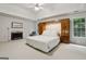 Spacious main bedroom features a fireplace, tray ceiling and built-in headboard and storage at 770 Spalding Heights Dr, Atlanta, GA 30350