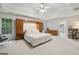 Spacious main bedroom features tray ceiling, built-in headboard and ensuite bathroom at 770 Spalding Heights Dr, Atlanta, GA 30350
