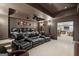 Home theater with black leather recliners, projector, screen and access to pool table area at 770 Spalding Heights Dr, Atlanta, GA 30350