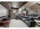 Home theater room with tiered seating, projector, screen, and comfortable leather chairs at 770 Spalding Heights Dr, Atlanta, GA 30350