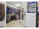 Large walk-in closet features built-in shelving and ample storage for clothing and accessories at 770 Spalding Heights Dr, Atlanta, GA 30350