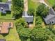 Aerial view of the property and backyard area, surrounded by mature trees and landscaping at 404 Northwind Pl, Stockbridge, GA 30281