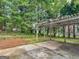 Covered pergola and patio area with mature trees offering privacy in the backyard at 404 Northwind Pl, Stockbridge, GA 30281