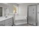 Bathroom featuring garden tub, separate glass shower and double sinks at 404 Northwind Pl, Stockbridge, GA 30281