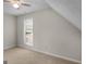 Neutral bedroom features a ceiling fan, window letting in natural light, and plush carpeting at 404 Northwind Pl, Stockbridge, GA 30281