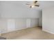 Neutral bedroom features a ceiling fan, plush carpeting, and an access panel at 404 Northwind Pl, Stockbridge, GA 30281