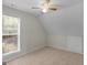 Neutral bedroom features a ceiling fan, window letting in natural light, and plush carpeting at 404 Northwind Pl, Stockbridge, GA 30281
