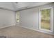 Bedroom featuring neutral colored carpet, gray walls, and lots of natural light at 404 Northwind Pl, Stockbridge, GA 30281