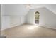 Neutral bedroom features a ceiling fan, plush carpeting, and arched window letting in natural light at 404 Northwind Pl, Stockbridge, GA 30281