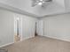 Spacious bedroom featuring tray ceiling, neutral paint, and plush carpeting at 404 Northwind Pl, Stockbridge, GA 30281
