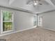 Spacious bedroom with plush carpet, tray ceilings, and lots of natural light at 404 Northwind Pl, Stockbridge, GA 30281