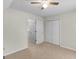 Neutral bedroom features a ceiling fan, plush carpeting, and a closet at 404 Northwind Pl, Stockbridge, GA 30281