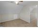 Neutral bedroom features a ceiling fan, plush carpeting, and attic access panel at 404 Northwind Pl, Stockbridge, GA 30281
