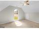 Neutral bedroom features a ceiling fan, plush carpeting, and arched window letting in natural light at 404 Northwind Pl, Stockbridge, GA 30281