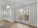 Dining area with a chandelier, a large window, and an entrance at 404 Northwind Pl, Stockbridge, GA 30281