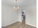 A dining room with a chandelier, hardwood floor, and entrance to the kitchen at 404 Northwind Pl, Stockbridge, GA 30281