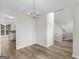 Dining room with hardwood floors leading to kitchen and stairs at 404 Northwind Pl, Stockbridge, GA 30281