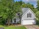 Charming two-story home with well-maintained lawn, mature trees and inviting front entrance at 404 Northwind Pl, Stockbridge, GA 30281
