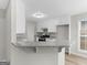 Open concept kitchen with white cabinets, granite countertops, and stainless steel appliances at 404 Northwind Pl, Stockbridge, GA 30281