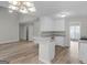 Open concept kitchen with granite countertops, white cabinets, and stainless steel appliances at 404 Northwind Pl, Stockbridge, GA 30281