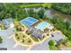 Aerial view of community amenities including tennis courts, swimming pool, and clubhouse by a serene pond at 4105 Vista Pointe Dr, Cumming, GA 30028