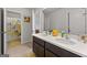 Bright bathroom featuring a double sink vanity with dark wood cabinets and a shower tub at 4105 Vista Pointe Dr, Cumming, GA 30028