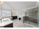 Modern bathroom featuring a soaking tub, glass shower, and tile floors at 4105 Vista Pointe Dr, Cumming, GA 30028