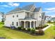 Side angle of home with brick, stone, and siding details, a welcoming porch, and beautifully maintained landscaping at 4105 Vista Pointe Dr, Cumming, GA 30028