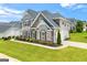 Charming home showcasing a combination of brick, stone, and siding, surrounded by a well-manicured lawn and garden at 4105 Vista Pointe Dr, Cumming, GA 30028