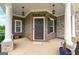 Inviting covered front porch features brick and stone accents, decorative lighting, and ample space for seating at 4105 Vista Pointe Dr, Cumming, GA 30028