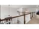 Second floor hallway with wooden railing overlooking fireplace at 4105 Vista Pointe Dr, Cumming, GA 30028