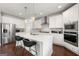 Modern kitchen featuring white cabinets, a center island with seating, and stainless steel appliances at 4105 Vista Pointe Dr, Cumming, GA 30028
