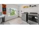 Bright laundry room with modern washer and dryer, large window, and ample storage space at 4105 Vista Pointe Dr, Cumming, GA 30028