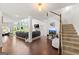 Open-concept living room with large windows, hardwood floors, and stairs leading to the second level at 4105 Vista Pointe Dr, Cumming, GA 30028