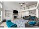 Open floor plan with a stone fireplace, large TV, built-in shelving, and a view of the upper level at 4105 Vista Pointe Dr, Cumming, GA 30028