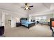 Large main bedroom featuring a tray ceiling, neutral carpet, and lots of natural light at 4105 Vista Pointe Dr, Cumming, GA 30028