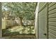 A secluded backyard with a storage shed and privacy fence surrounded by shade trees at 5599 Fair Creek Way, Lithonia, GA 30038