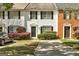 Charming townhouse with a driveway and manicured front yard featuring lush greenery at 5599 Fair Creek Way, Lithonia, GA 30038