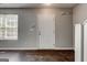 Spacious living room featuring hardwood floors, neutral paint, and ample natural light at 5599 Fair Creek Way, Lithonia, GA 30038