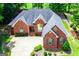 Charming brick home with well-manicured landscaping, a spacious driveway, mature trees, and welcoming curb appeal at 109 National Way, Carrollton, GA 30116