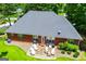 Aerial view of a brick home showcasing a well-maintained backyard, patio, and lush greenery at 109 National Way, Carrollton, GA 30116