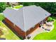 Aerial of brick house, gray roof, large back yard and patio with green lawn at 109 National Way, Carrollton, GA 30116