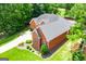 Brick home with well manicured lawns and landscaping, complimented by mature trees, offering a private front and backyard setting at 109 National Way, Carrollton, GA 30116