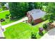 Brick home with well manicured lawns and landscaping, complimented by mature trees, offering a private front and backyard setting at 109 National Way, Carrollton, GA 30116