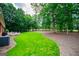 Lush backyard with mature trees and manicured lawn offering a serene outdoor setting at 109 National Way, Carrollton, GA 30116