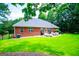 Expansive backyard features lush green grass, a patio set, and privacy provided by mature trees at 109 National Way, Carrollton, GA 30116
